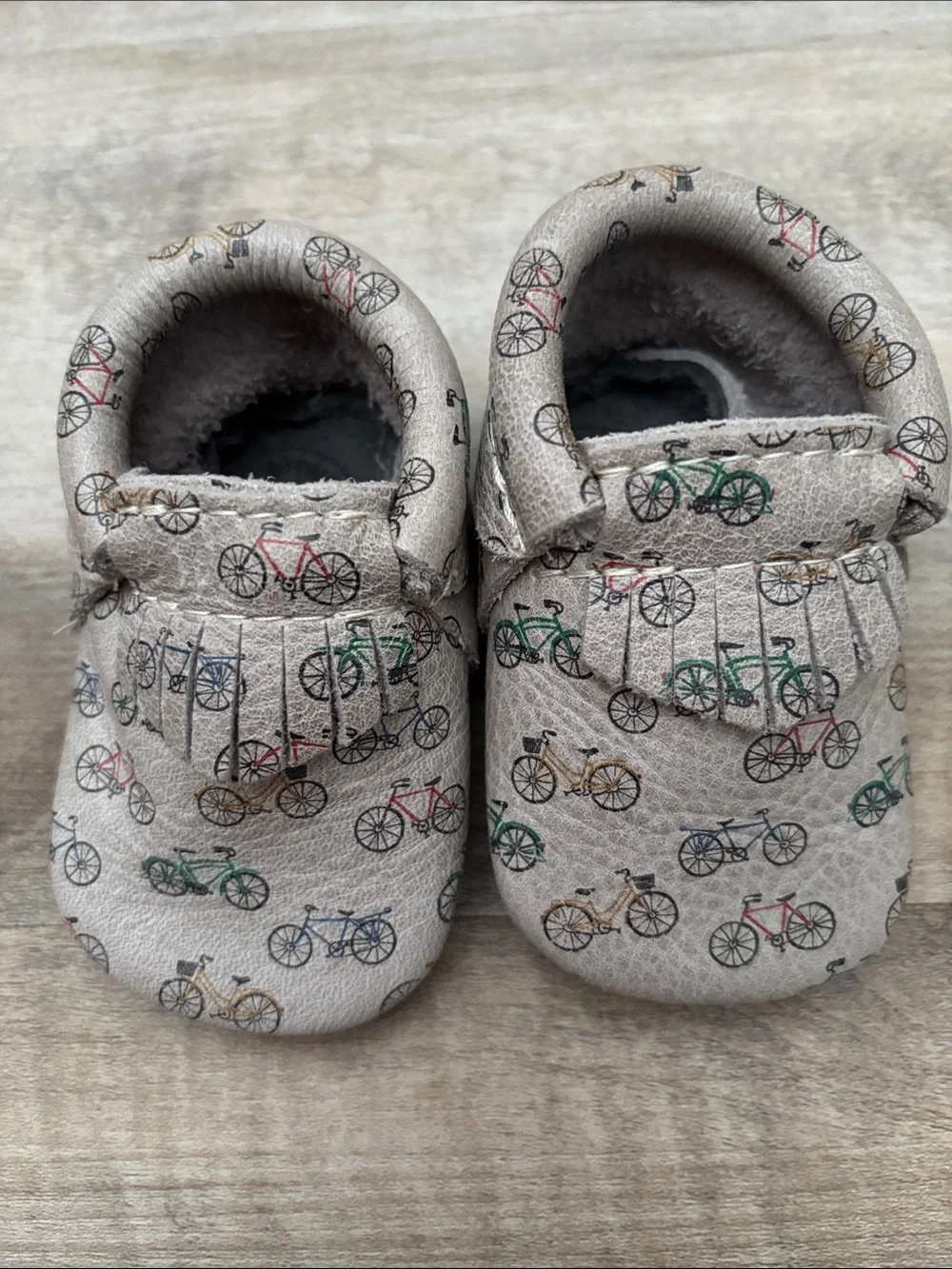 Freshly Picked Beige Baby Moccasins with Multicolor Bicycle Print